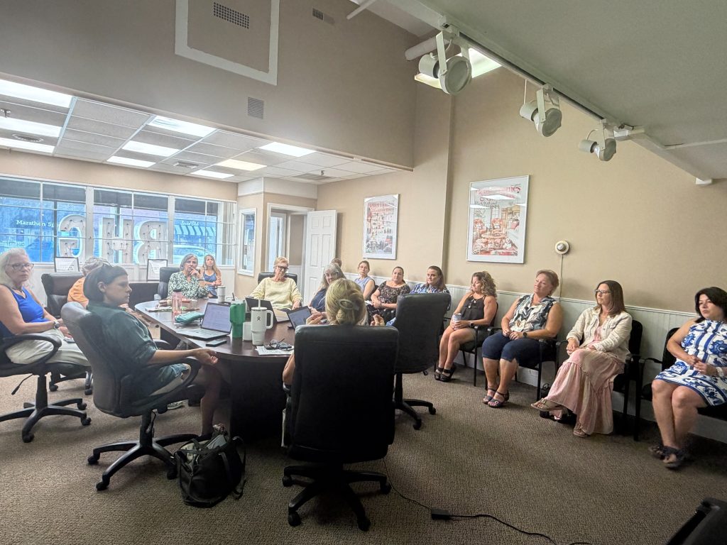 Real estate agents participating in a brokerage training and coaching session
